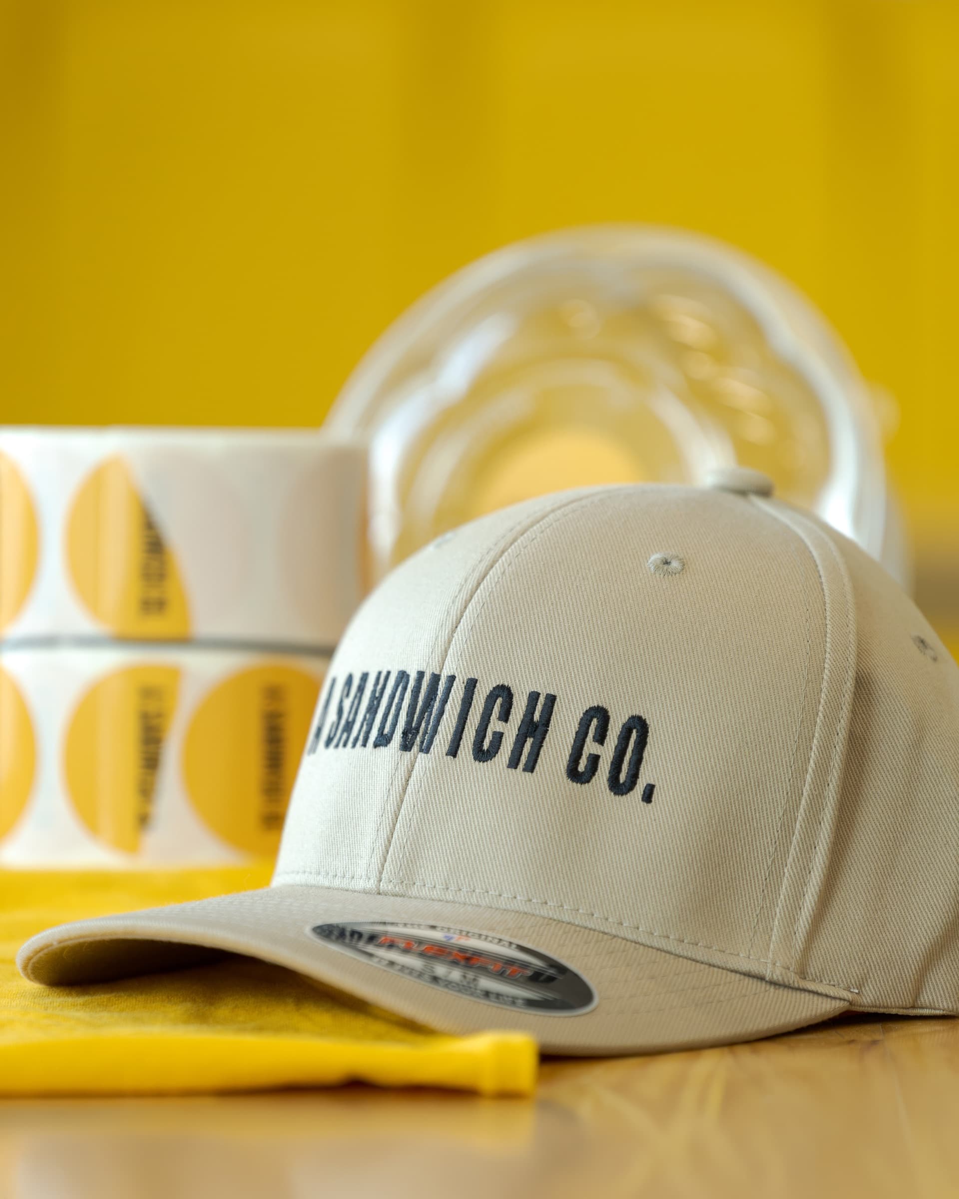 Cream A Sandwich Co. hat with branded packaging