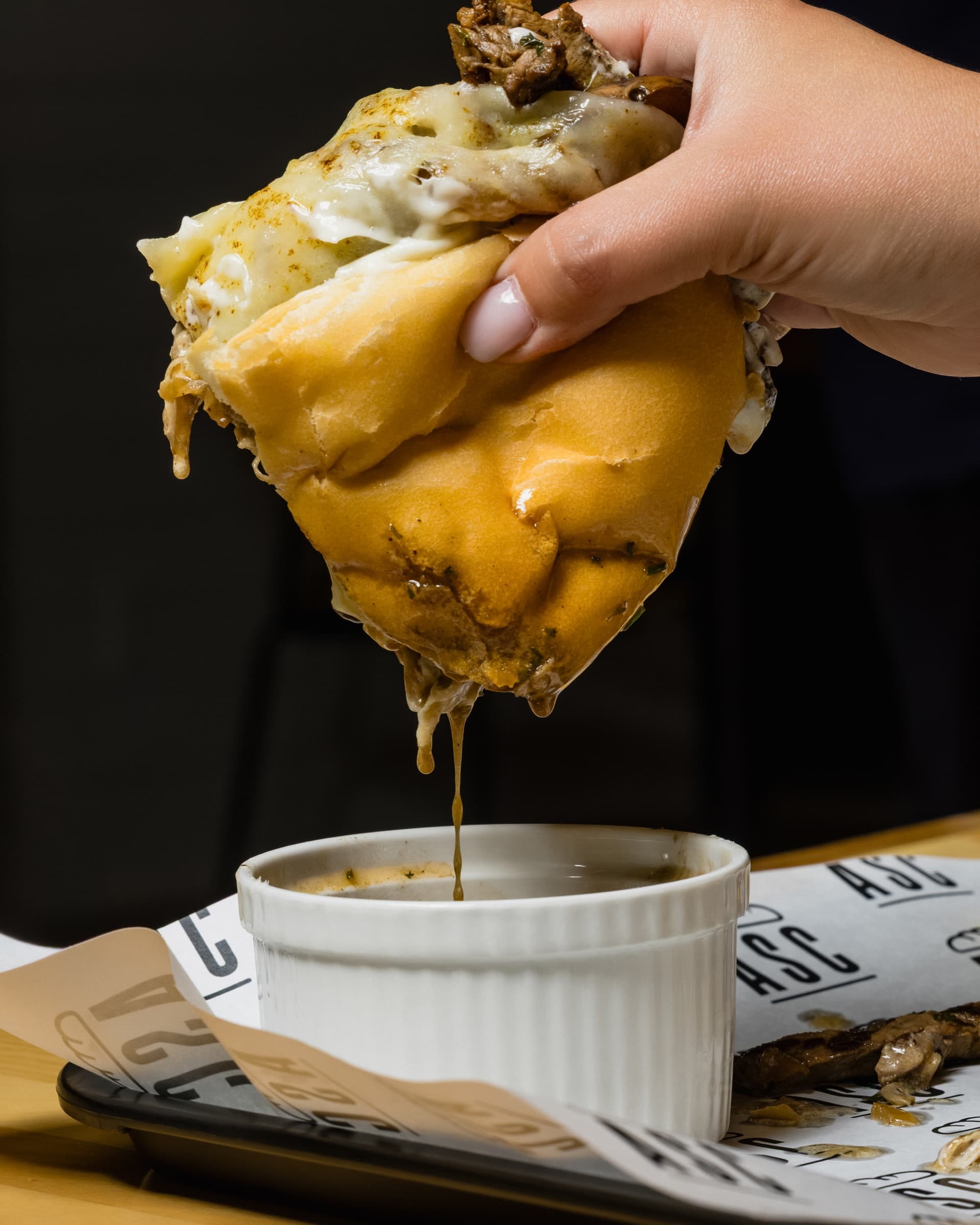 Ribeye dip sandwich served with au jus